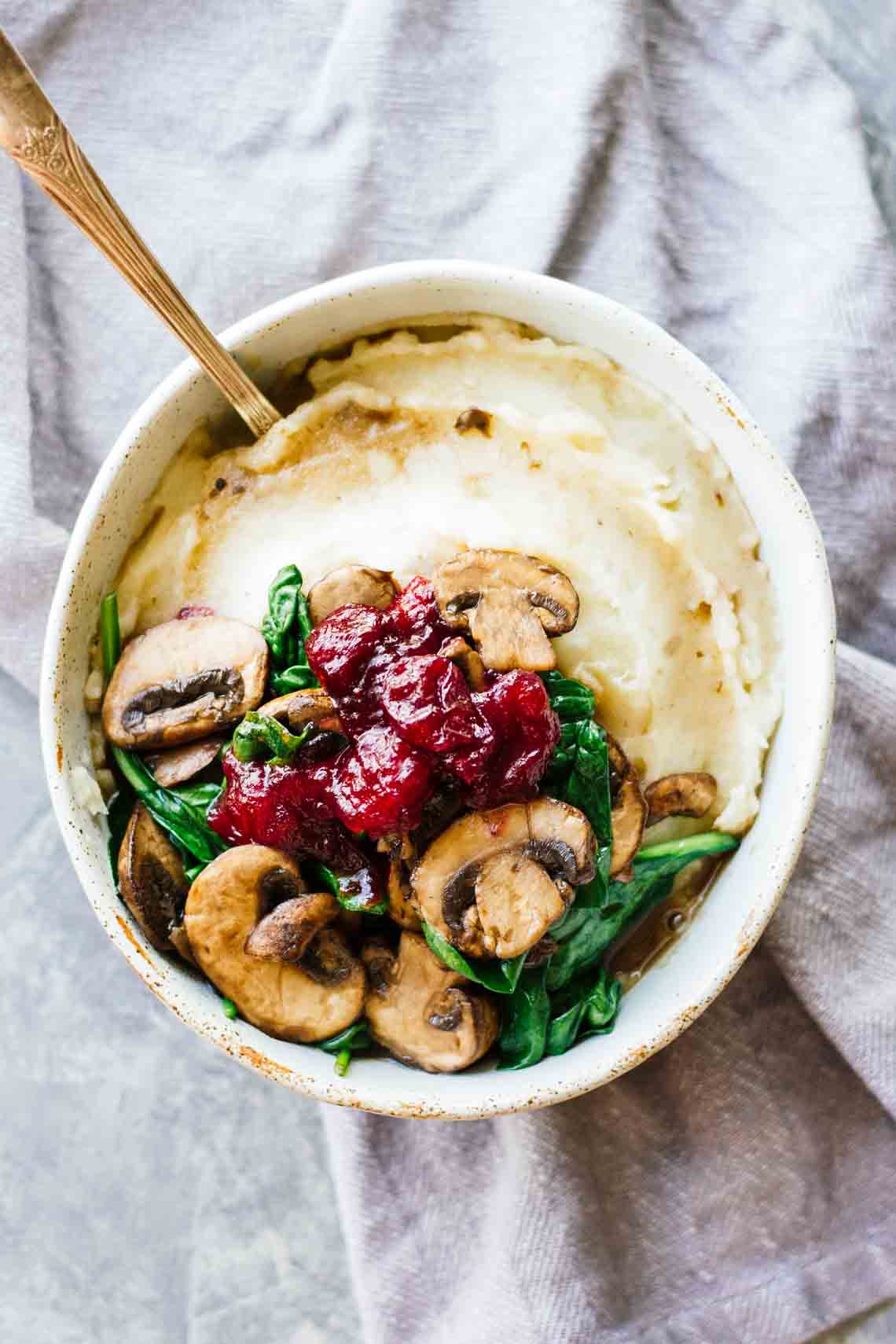 Vegan Slow Cooker Mashed Potatoes & Cranberry Mushroom Sauce // A tiny Thanksgiving-bowl that's perfect for Winter too. It's comforting thanks to the mash, healthy thanks to the mushrooms with greens and flavorful thanks to the cranberry sauce. | The Green Loot #vegan #cleaneating #weightloss